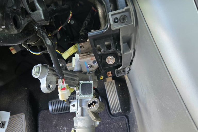 Car ignition cylinder exposed with steering column trim removed