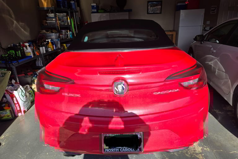 Red Buick Cascada parked in garage