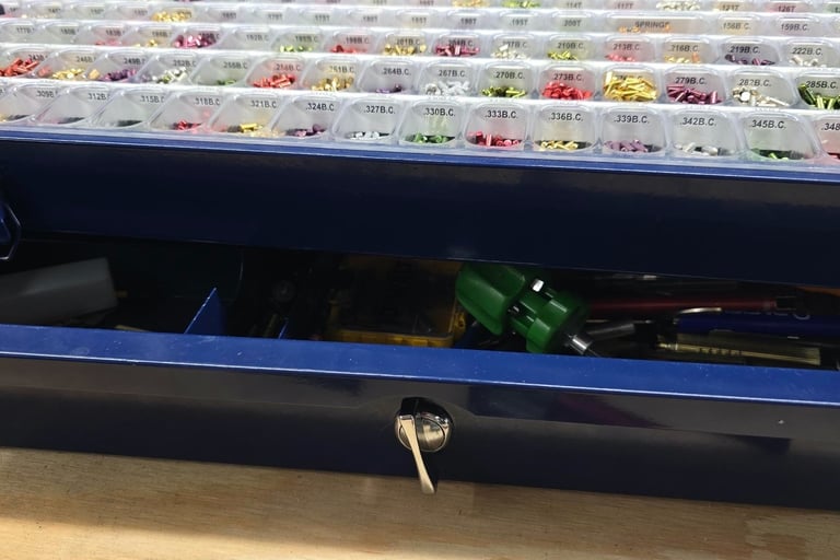 Close-up of lock rekeying pins and tools on a workbench