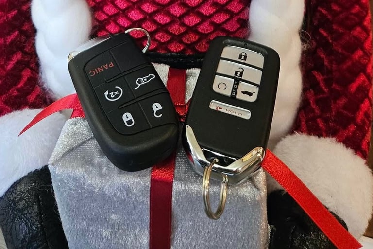 Two Honda key fobs placed on a Christmas-themed background