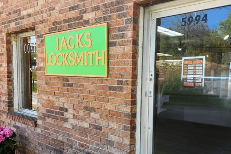 Green and orange "Jack's Locksmith" storefront sign in Burnsville, North Carolina