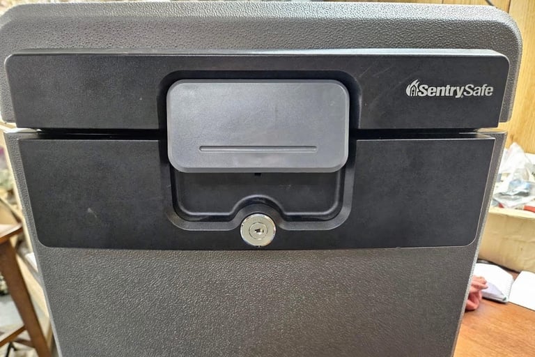 Professional locksmith servicing a SentrySafe fireproof home safe