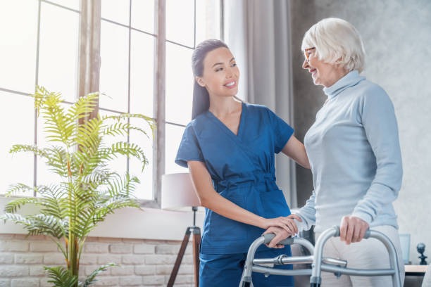 Physical therapy: performing gait training with a geriatric patient at home.
