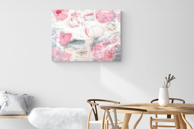 Painting of abstract pink roses on wall in dining room with Wegner chairs