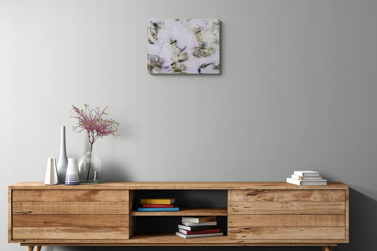 small violet and green painting above cabinet.