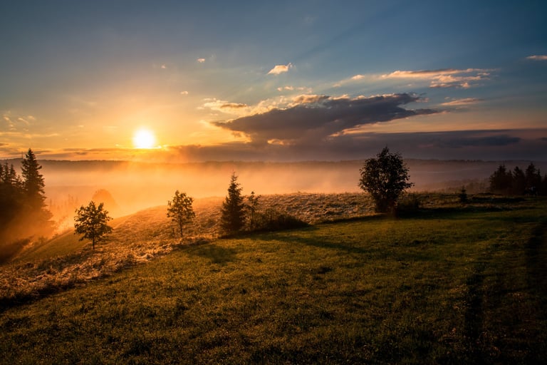 sunrise from hilltop overlooking a misty valley