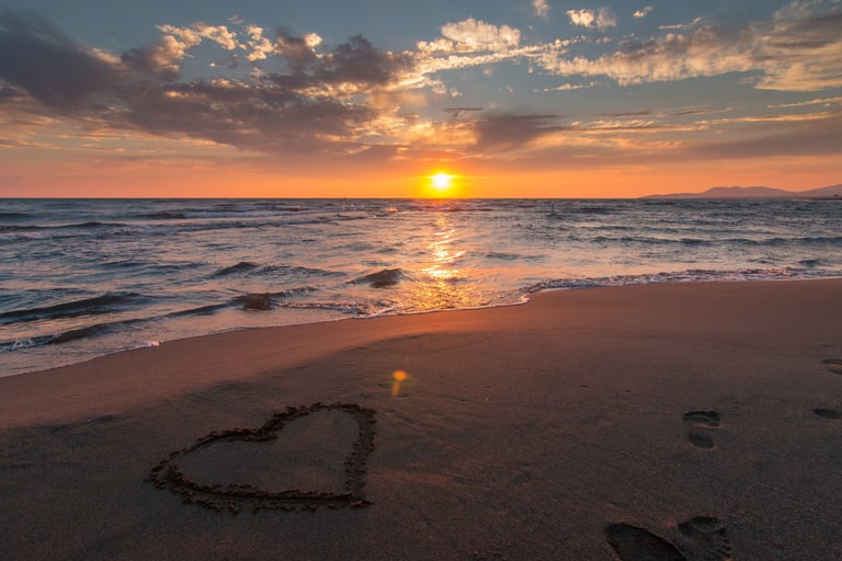 sunset at a beach overlooking a sea