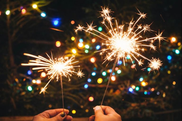 Hands holding sparklers during a shared evening moment, slow living moments