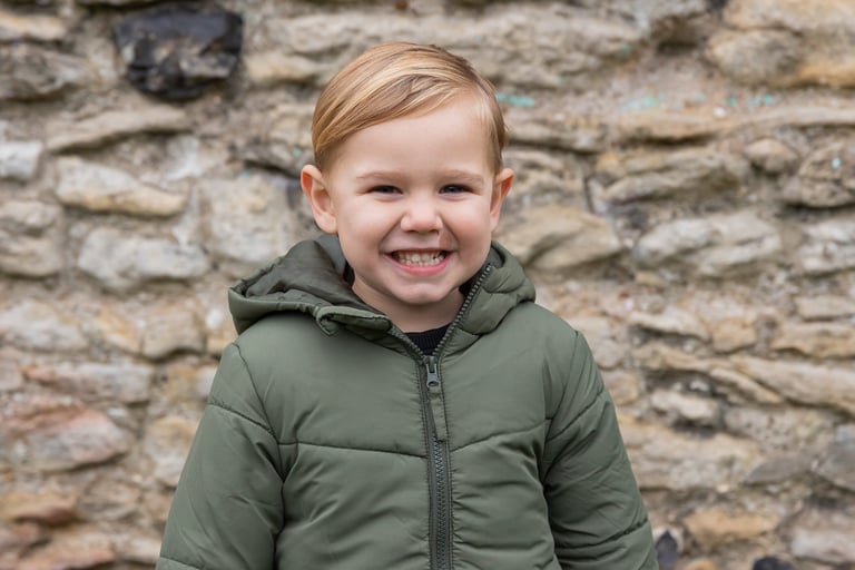 boy smiling towards the camera in a park in Bexley