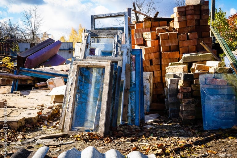 construction debris stacked on empty lot