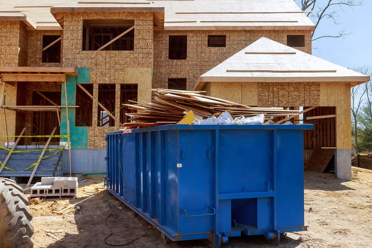 construction debris piled in dumpster 