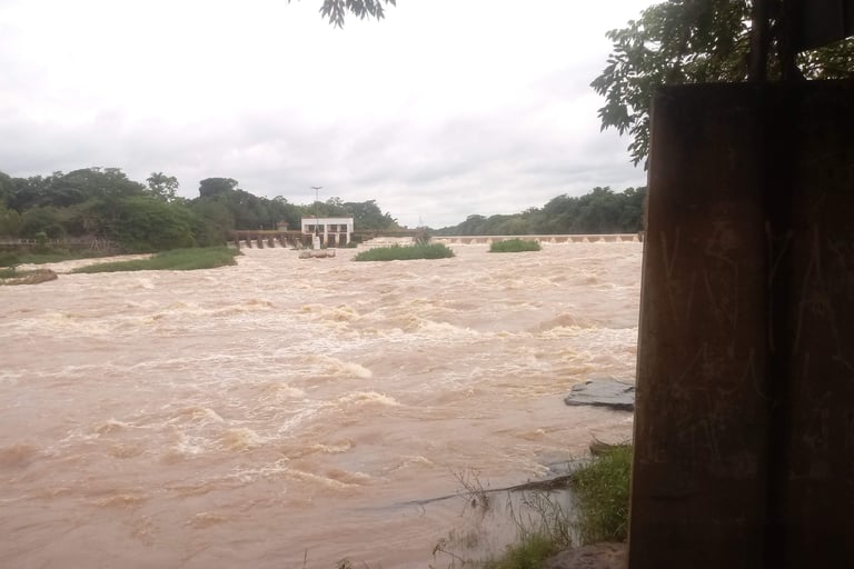 a river with a bridge and a bridge in the background