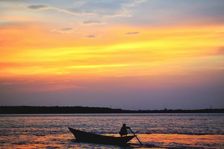 Man paddling at sunset on Ohio lake, reflecting Buckeye Venture Group’s real estate vision