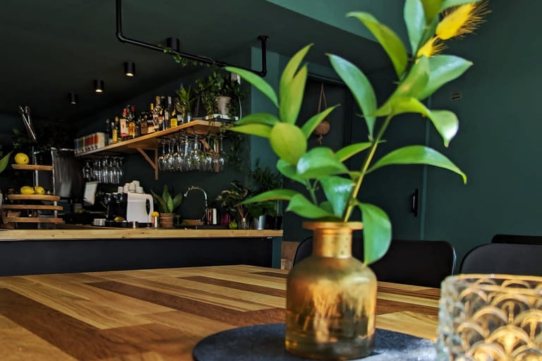 a vase with a plant in it sitting on a table