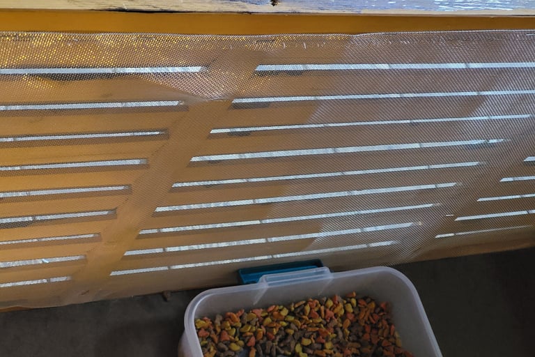 Screening over slats inside box.