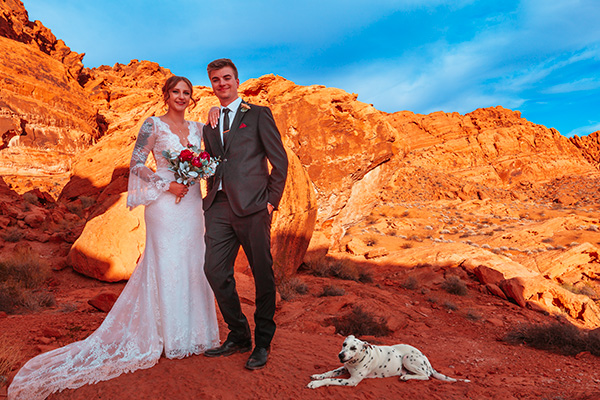 a man and woman standing in front of a mountain