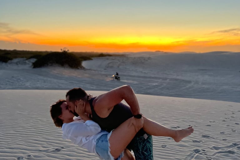 a man and woman are kissing on the beach