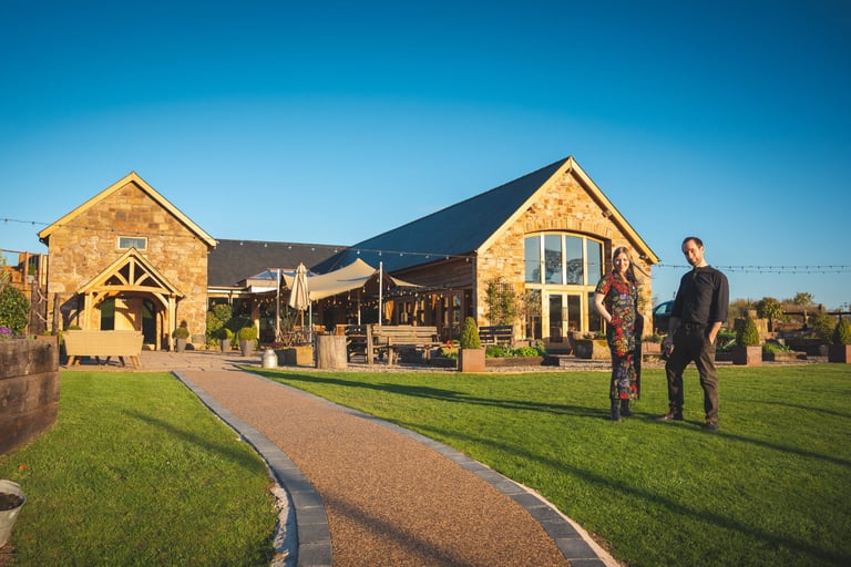 man and woman standing in front of wedding venue