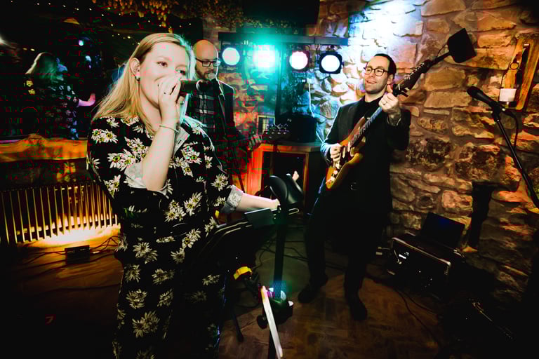 Singer and guitarist performing at wedding with band