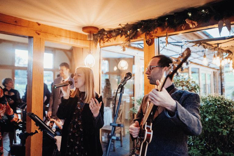 singer and guitarist performing at wedding reception