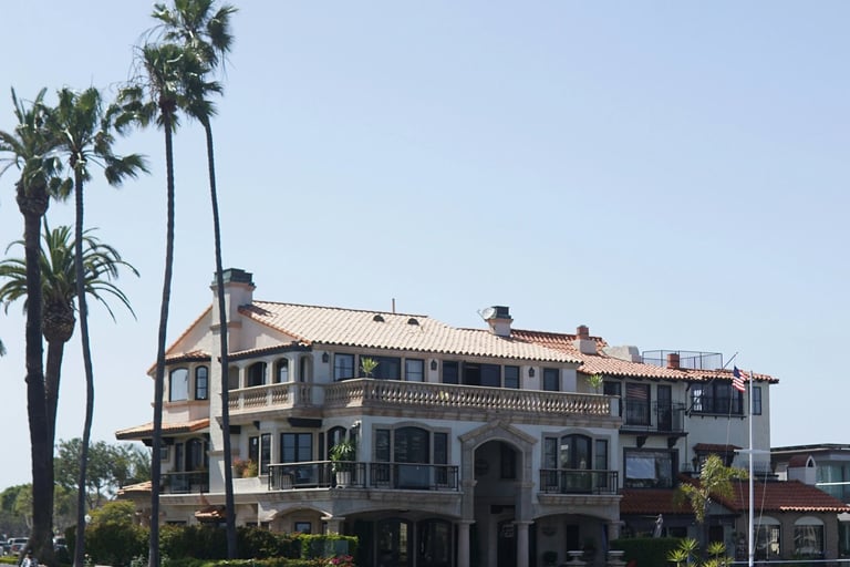 a large house with a dock and palm trees
