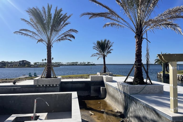 a large pool with a hot tub and palm trees
