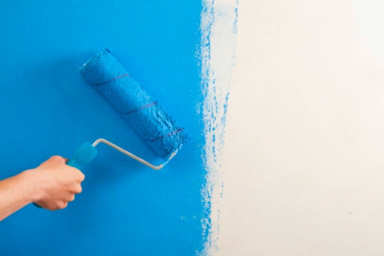 Rolling blue paint on wall