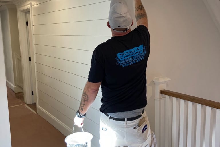 Michael Cummings painting interior walls in Duxbury, MA home using professional brushstrokes