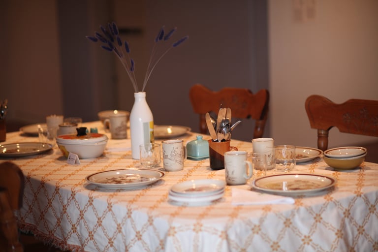 Empty table with recycled kitchenware in a gallery playing sounds of cooking and shared meals.