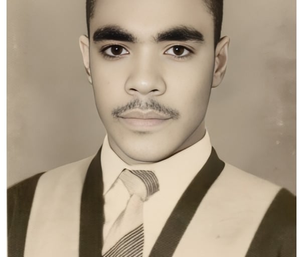 a man in a suit and tie with a mustache
