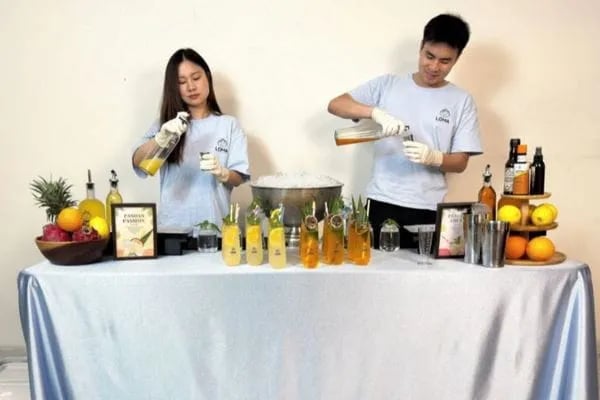 The Loma bartender team on the mobile bar making drinks for customers.