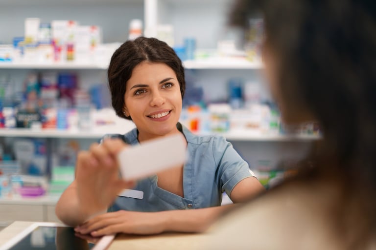 a woman in a pharmacy office setting with a business card