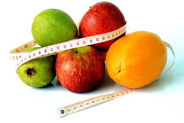 Pile of mixed fruits with tape measure