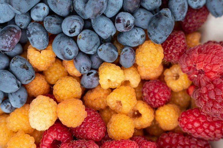 Gold and red raspberries with blueberries