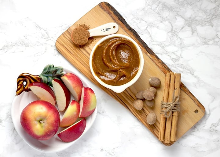 Apples with caramel on cutting board