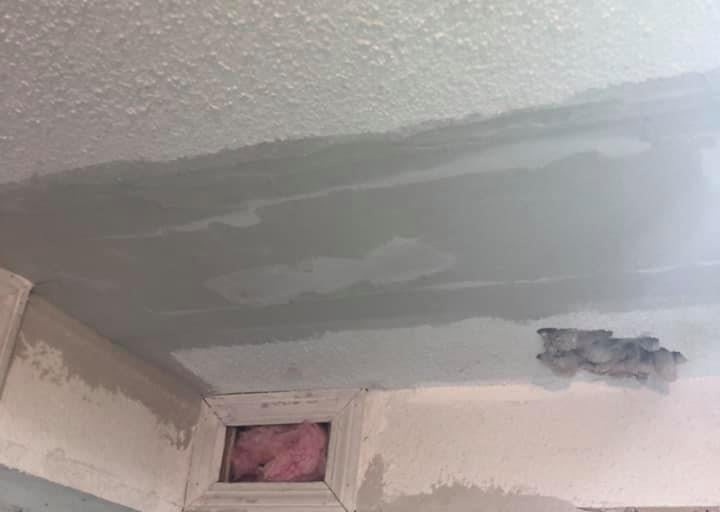 drywall ceiling with popcorn texture is being repaired a large patch
