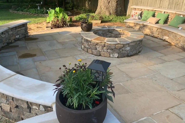 a concrete patio with a stone fire pit
