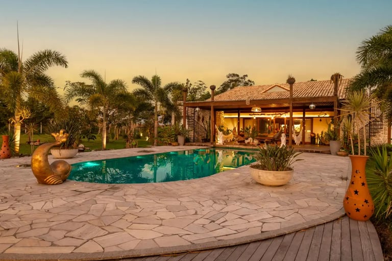 a pool with a stone concrete patio 