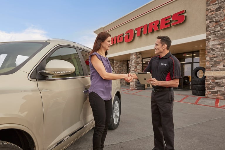 A Big O Tires employee helping a customer