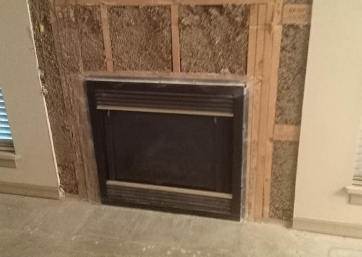 a fireplace with a fireplace in the middle of a room