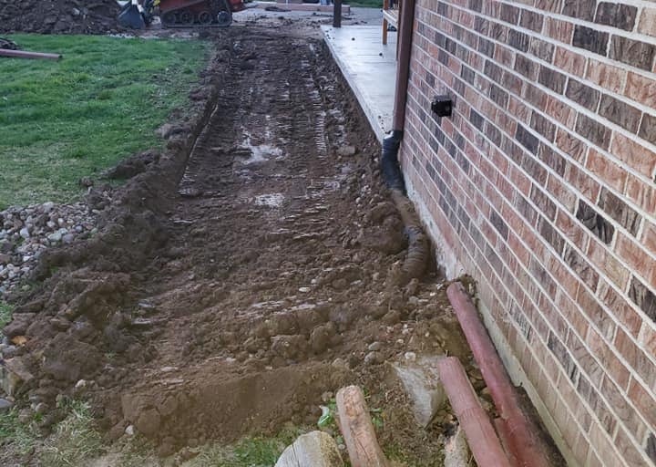 a brick wall and a fire hydrant in a yard