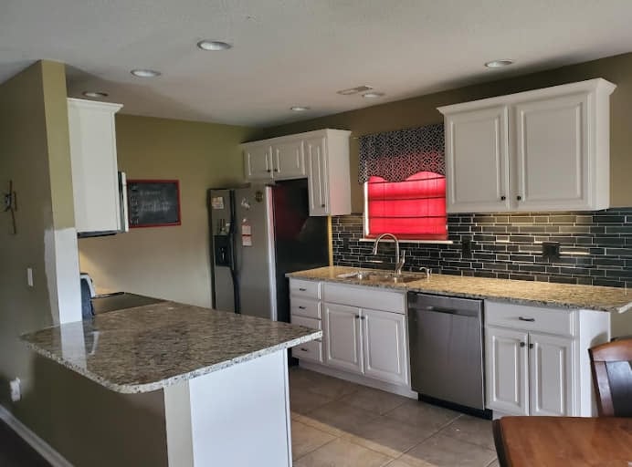 a kitchen with a table and chairs and a table