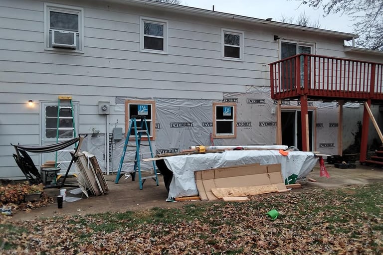 a house with a deck and a deck with a table and chairs