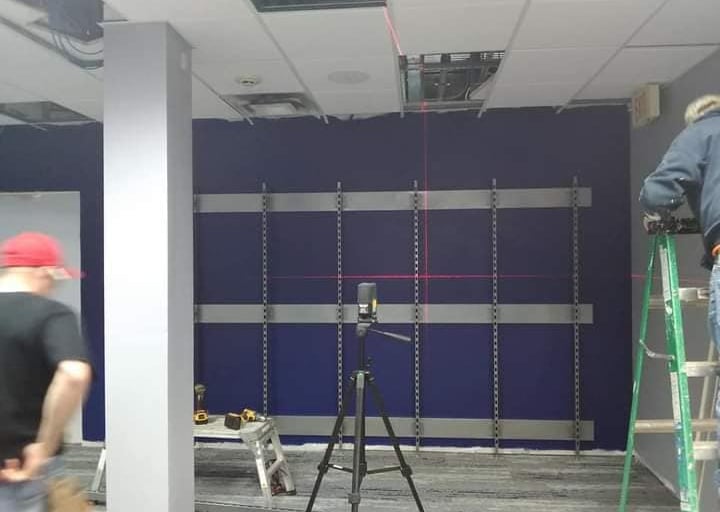 a man standing on a ladder ladder to get a picture of a man in a