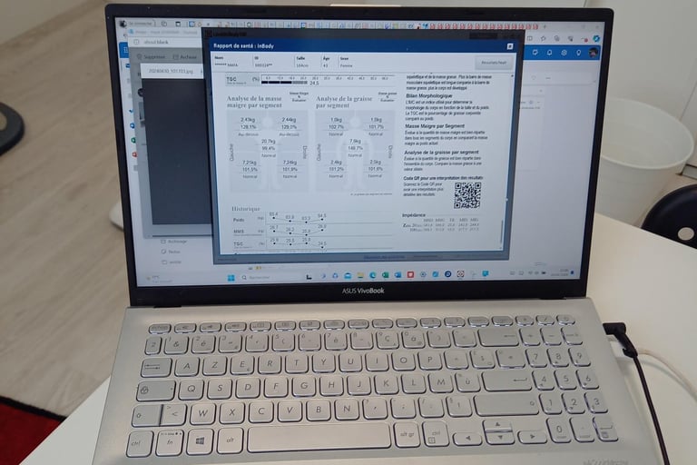 a laptop computer sitting on a table with a keyboard