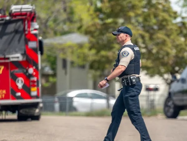 Ada County Sheriff Deputy crossing the street behind a fire truck in Idaho.