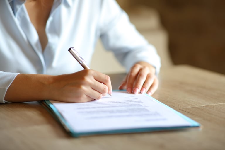 Woman signs court form with pen