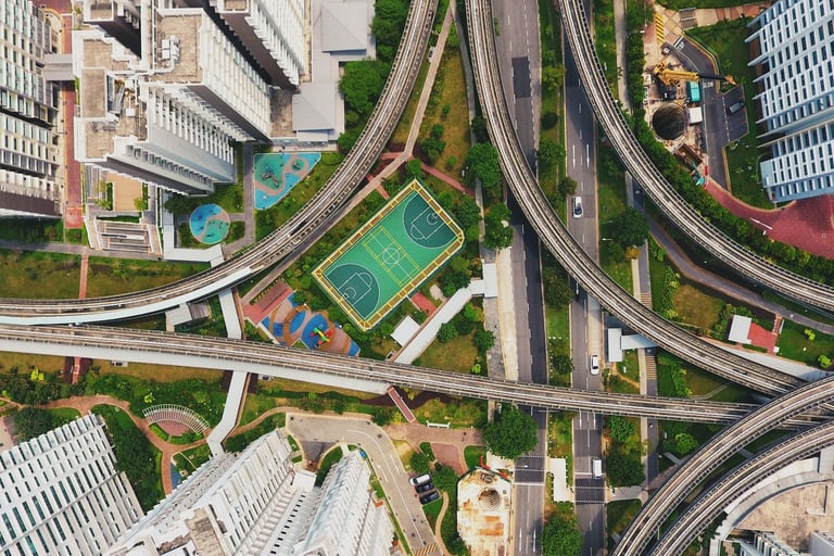 Aerial photograph of urban environment showing skyscrapers, green space, and highways.