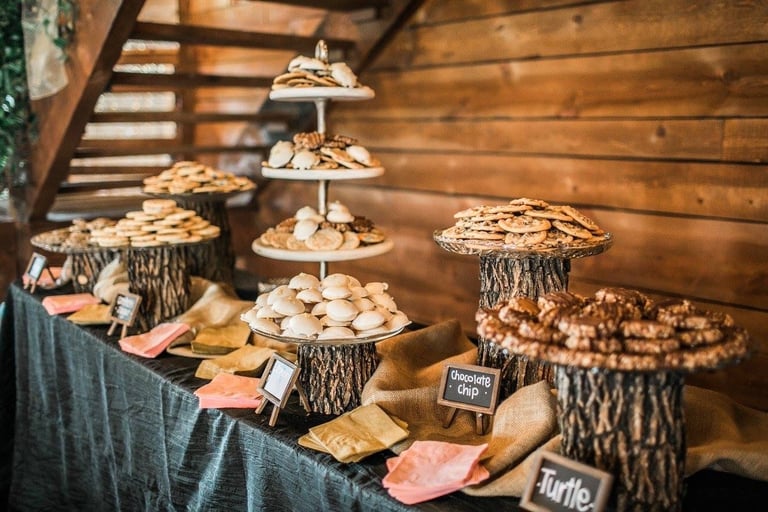 Rustic wedding dessert table catering with assorted cookies on wooden stands in Decatur TX
