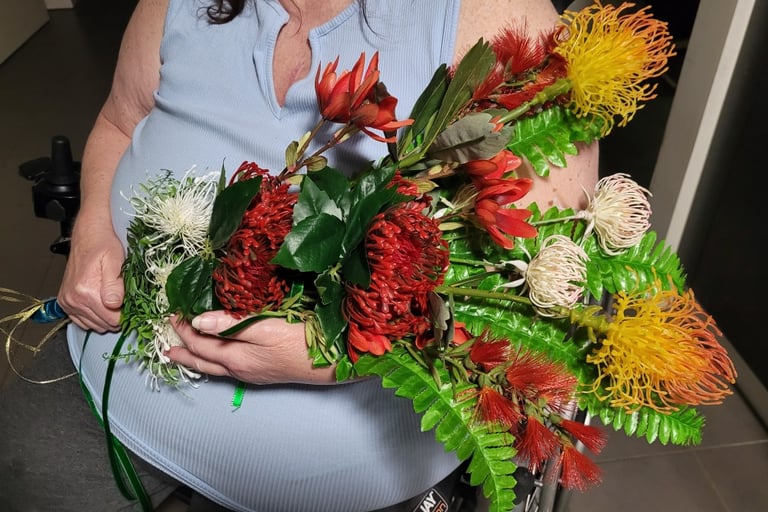 Native flower bouquet being held